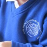 Wroxton Primary School badge on a blue jumper