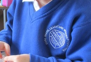 Wroxton Primary School badge on a blue jumper