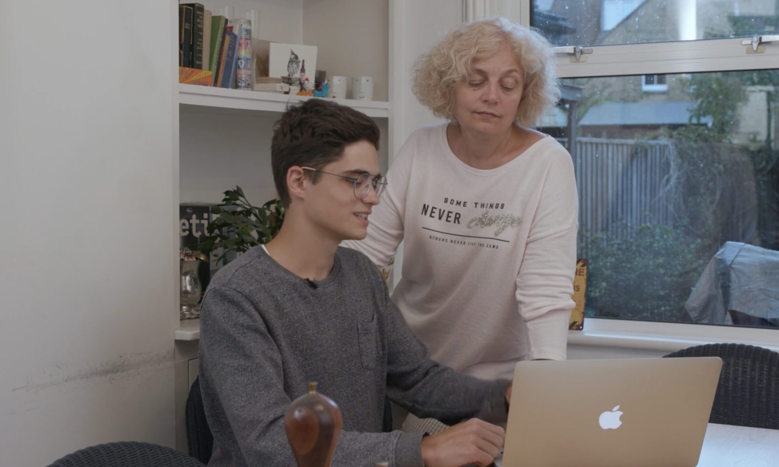 Anton with his Mum using his laptop donated by GOO